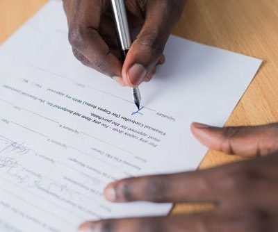 Person Signing Paper